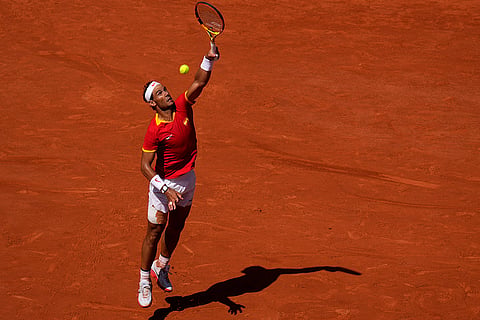 Rafael Nadal jumps to return the ball 